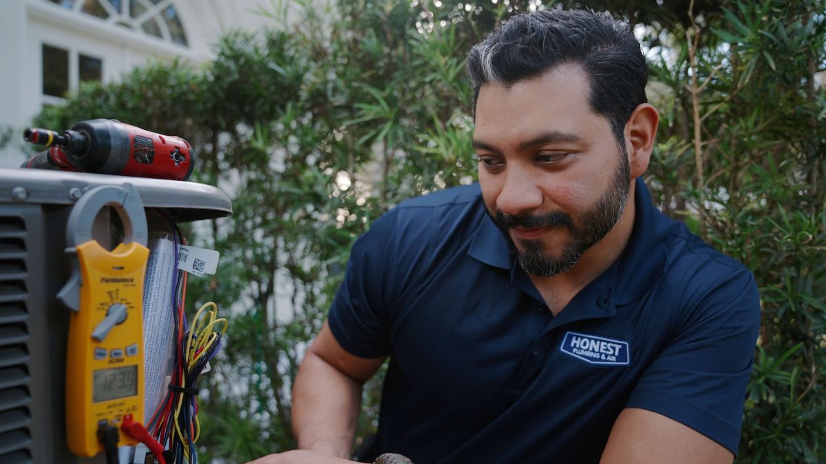 An AC Tech providing maintenance on an AC unit
