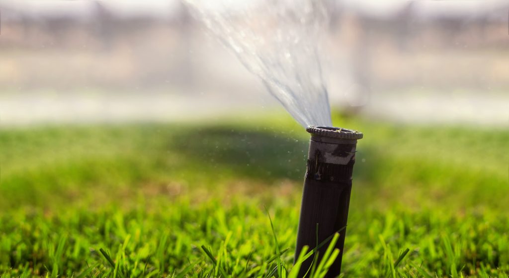 Automatic sprinkler system watering the lawn