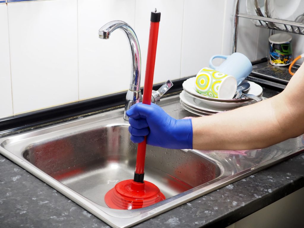 Removing blockage of the pipe, drain in the sink with a plunger