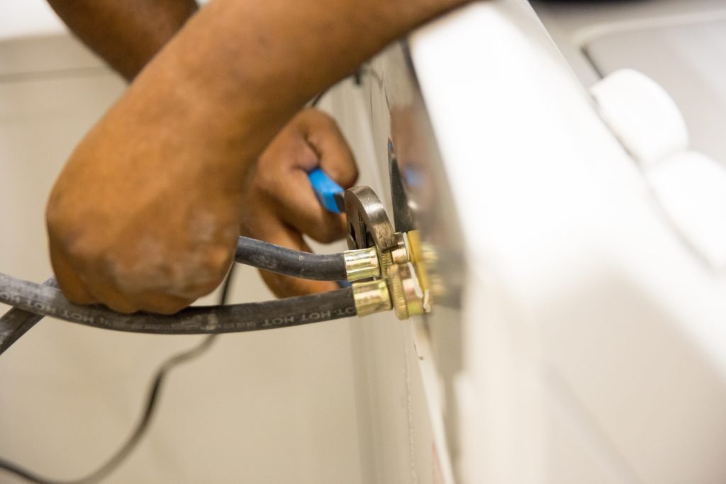 hands on water lines for washing machine