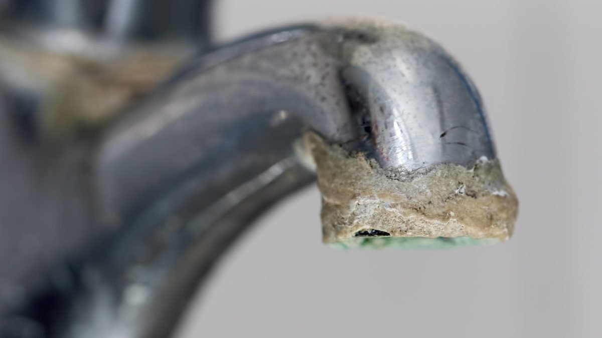 limescale buildup on end of faucet indicates hard water