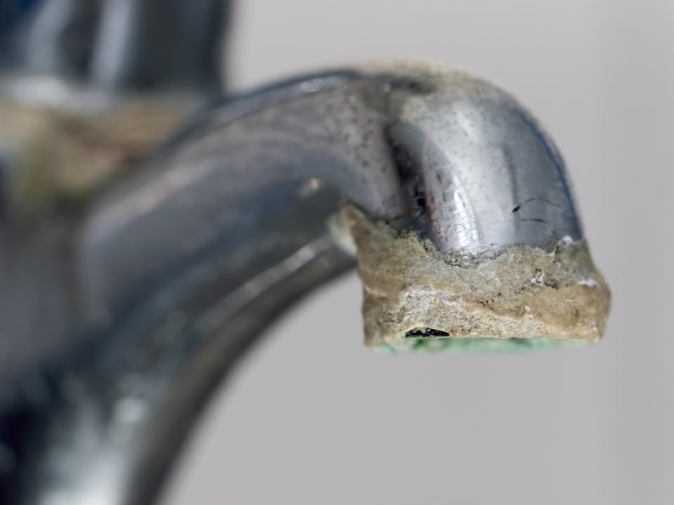limescale buildup on end of faucet indicates hard water