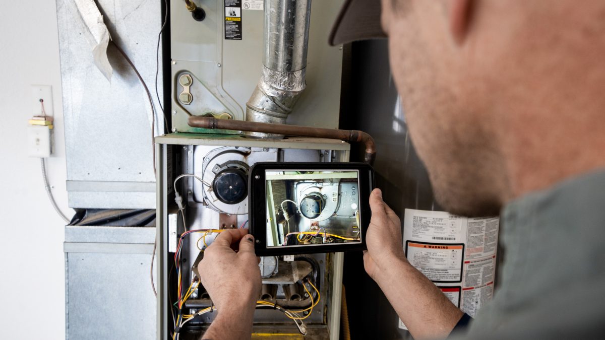 HVAC technician conducts a heating system tune-up