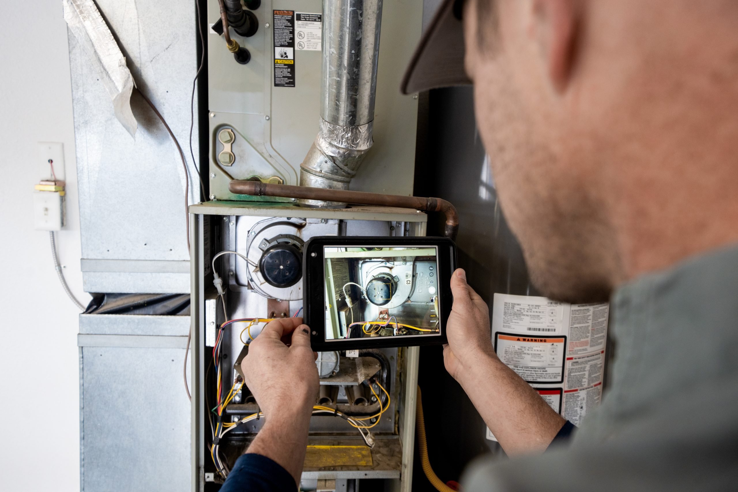 HVAC technician conducts a heating system tune-up