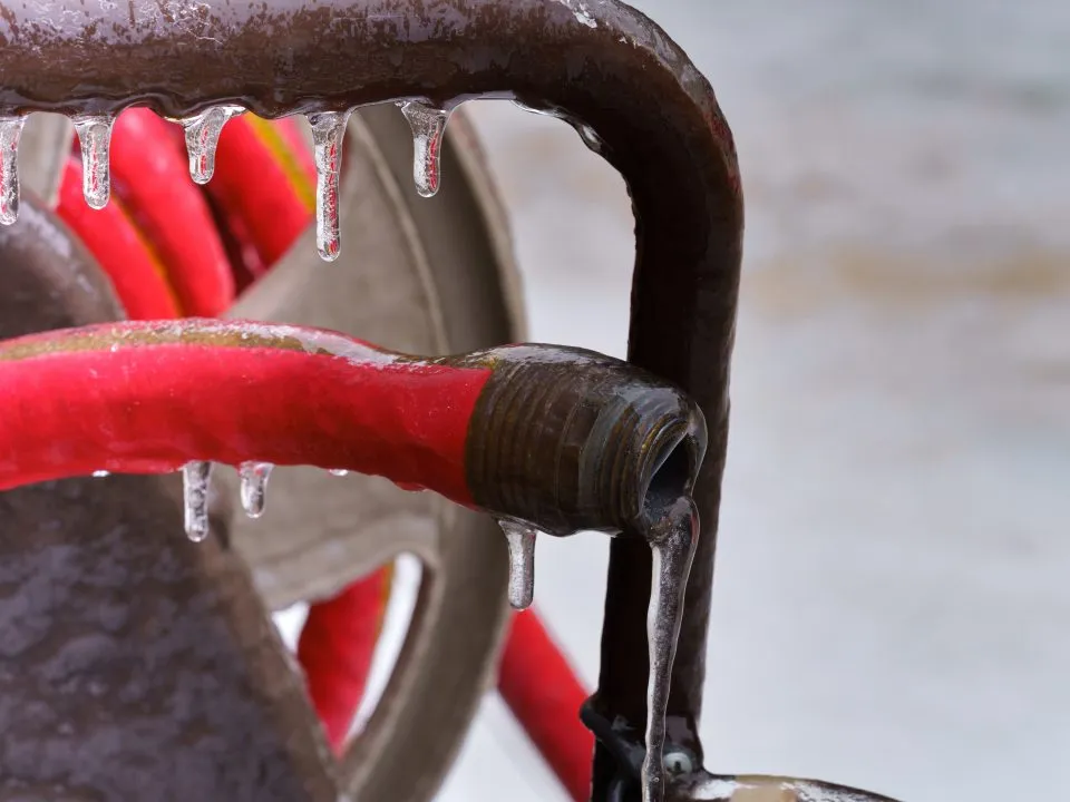 an ice encrusted garden hose is a common winter plumbing problem